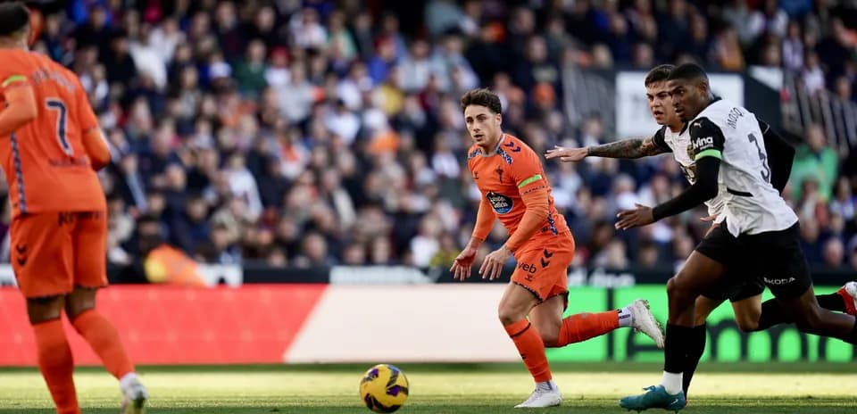Valencia player chasing the ball against Celta Vigo Valencia player chasing the ball against Celta Vigo