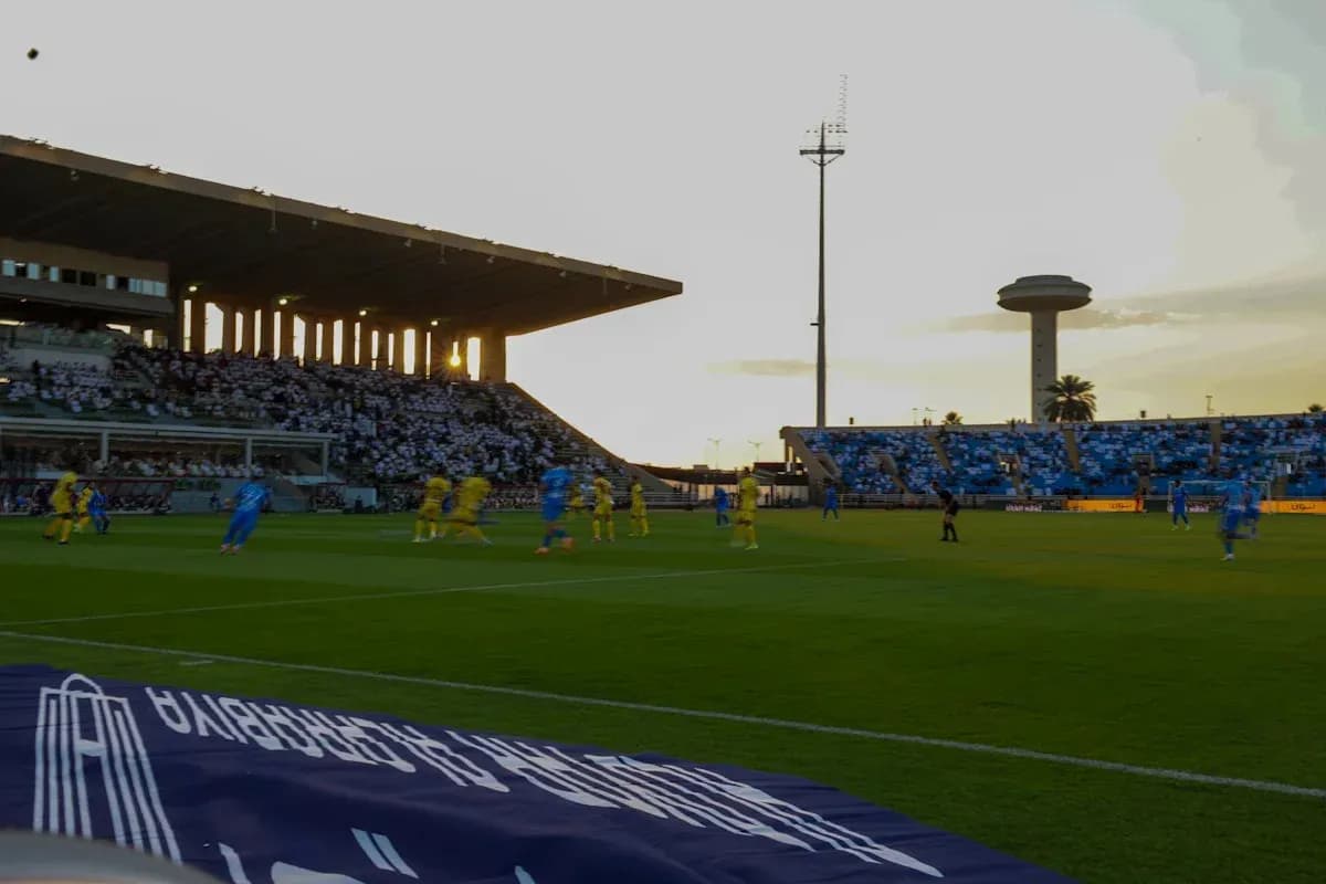 Players in blue and yellow competing on the field Players in blue and yellow competing on the field