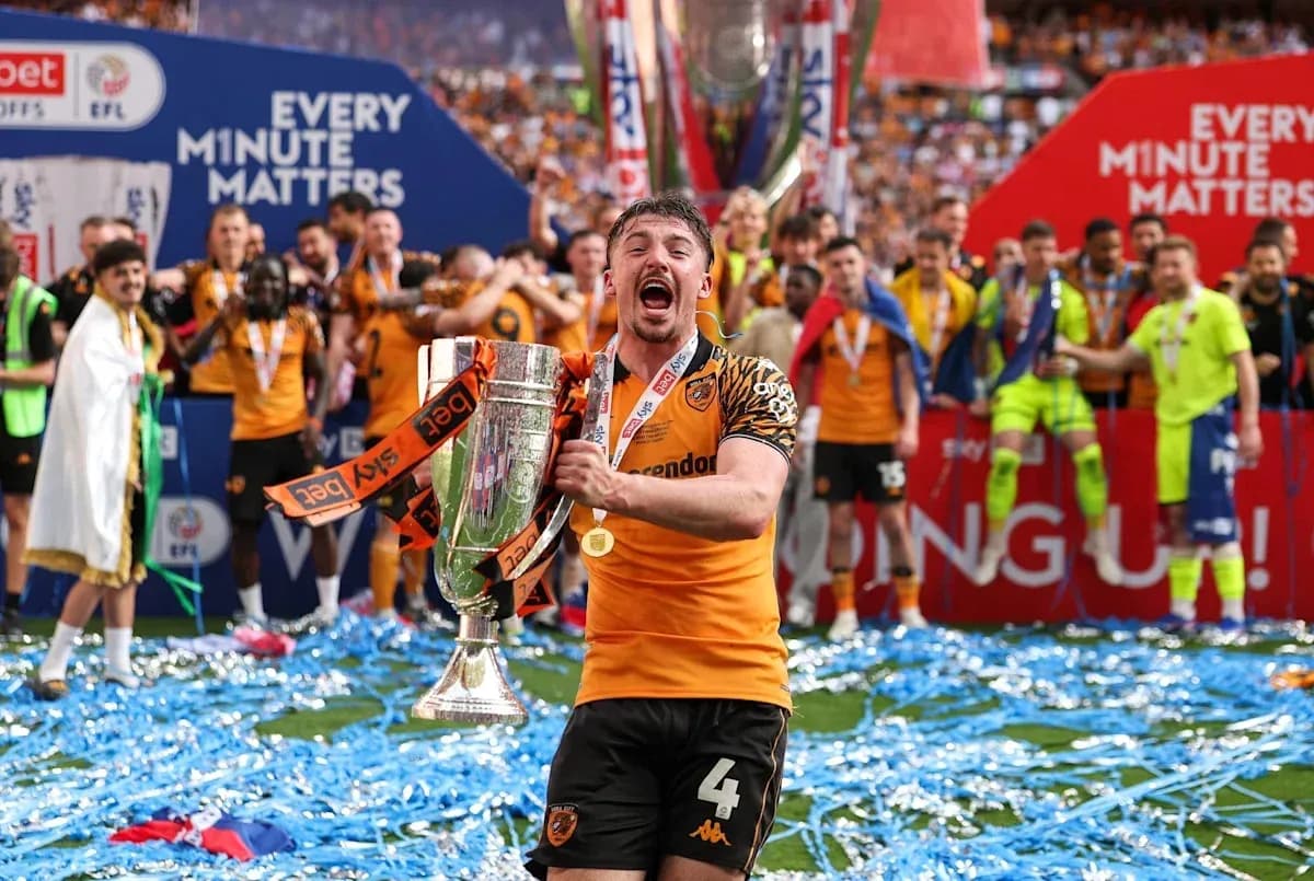 Player celebrating with trophy during victory parade Player celebrating with trophy during victory parade