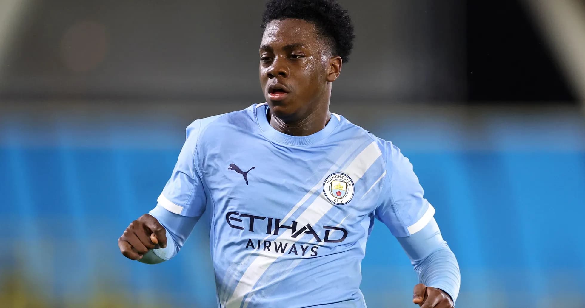 Player running during a Manchester City match Player running during a Manchester City match