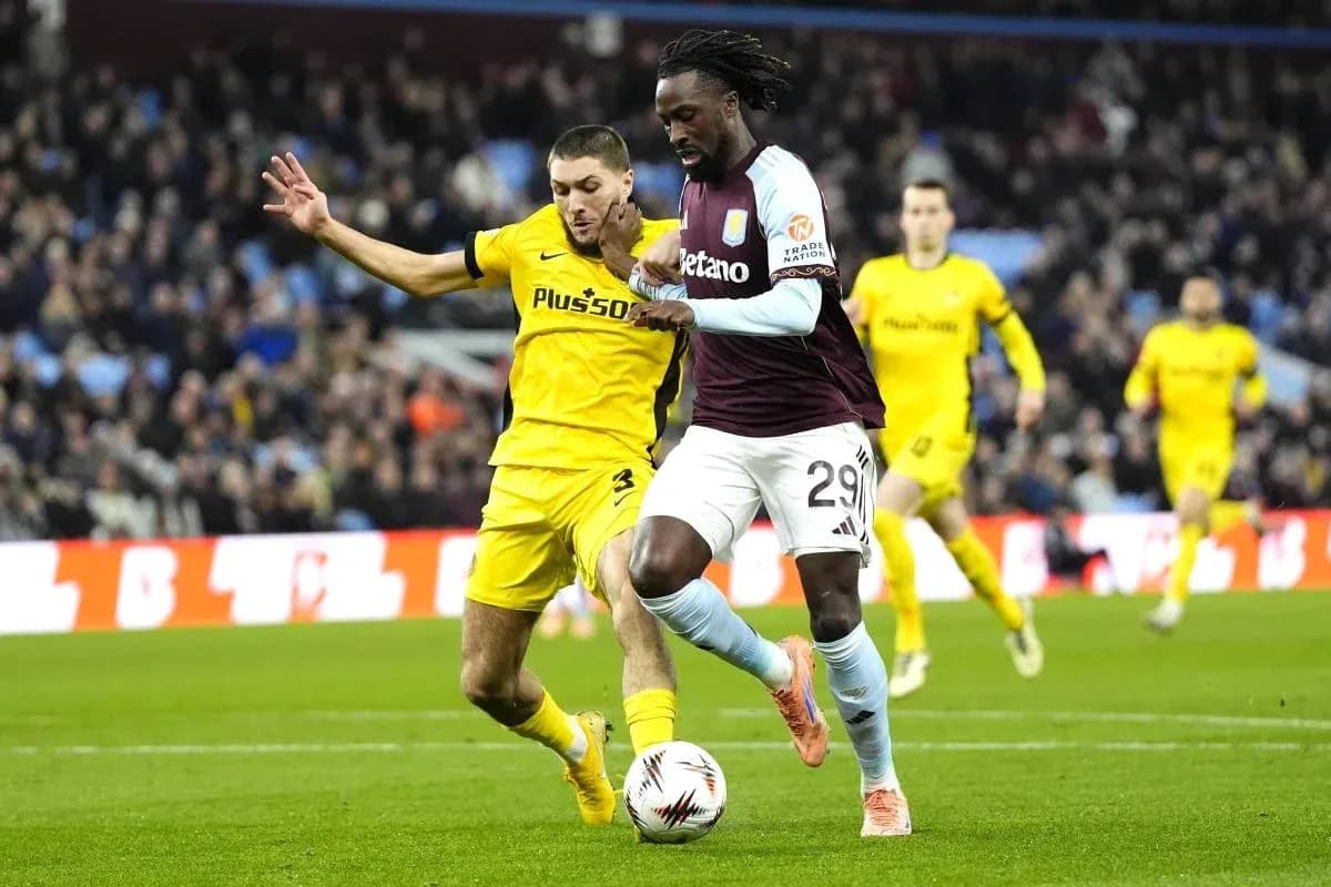 Player dribbling past opponent during football match Player dribbling past opponent during football match
