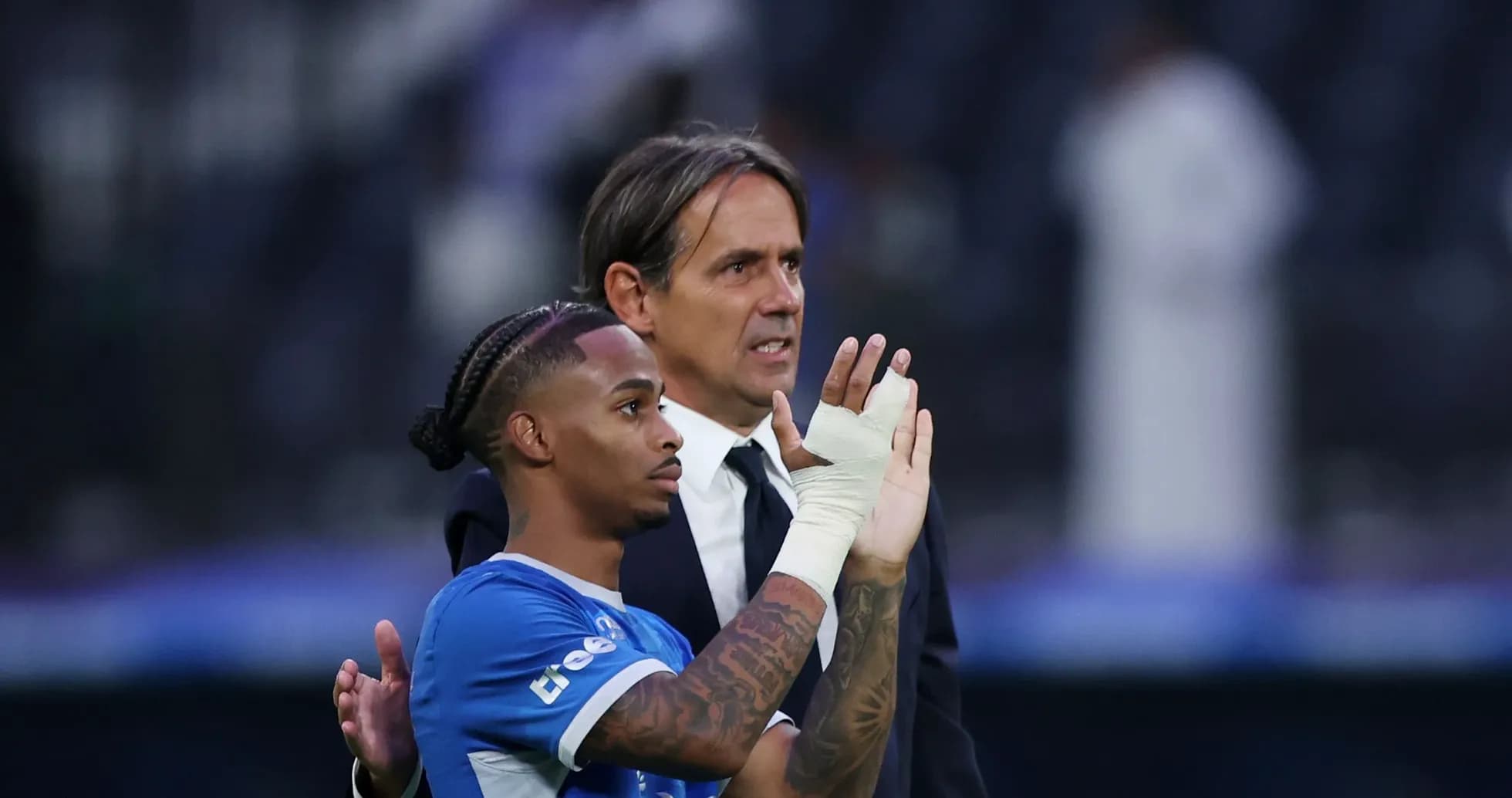 Player and coach acknowledging fans after match Player and coach acknowledging fans after match