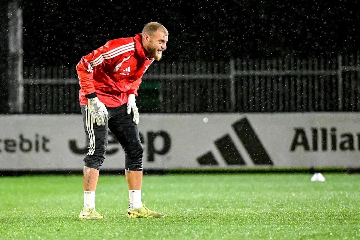 Goalkeeper training in rain at outdoor pitch Goalkeeper training in rain at outdoor pitch