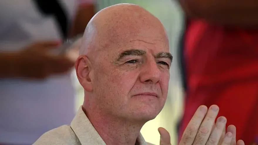 Man with bald head seated, hands clasped together Man with bald head seated, hands clasped together