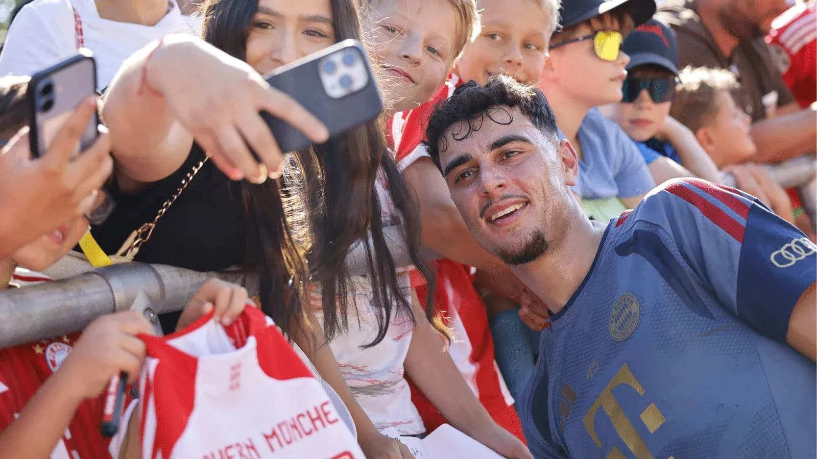 Player taking selfie with fans at event Player taking selfie with fans at event