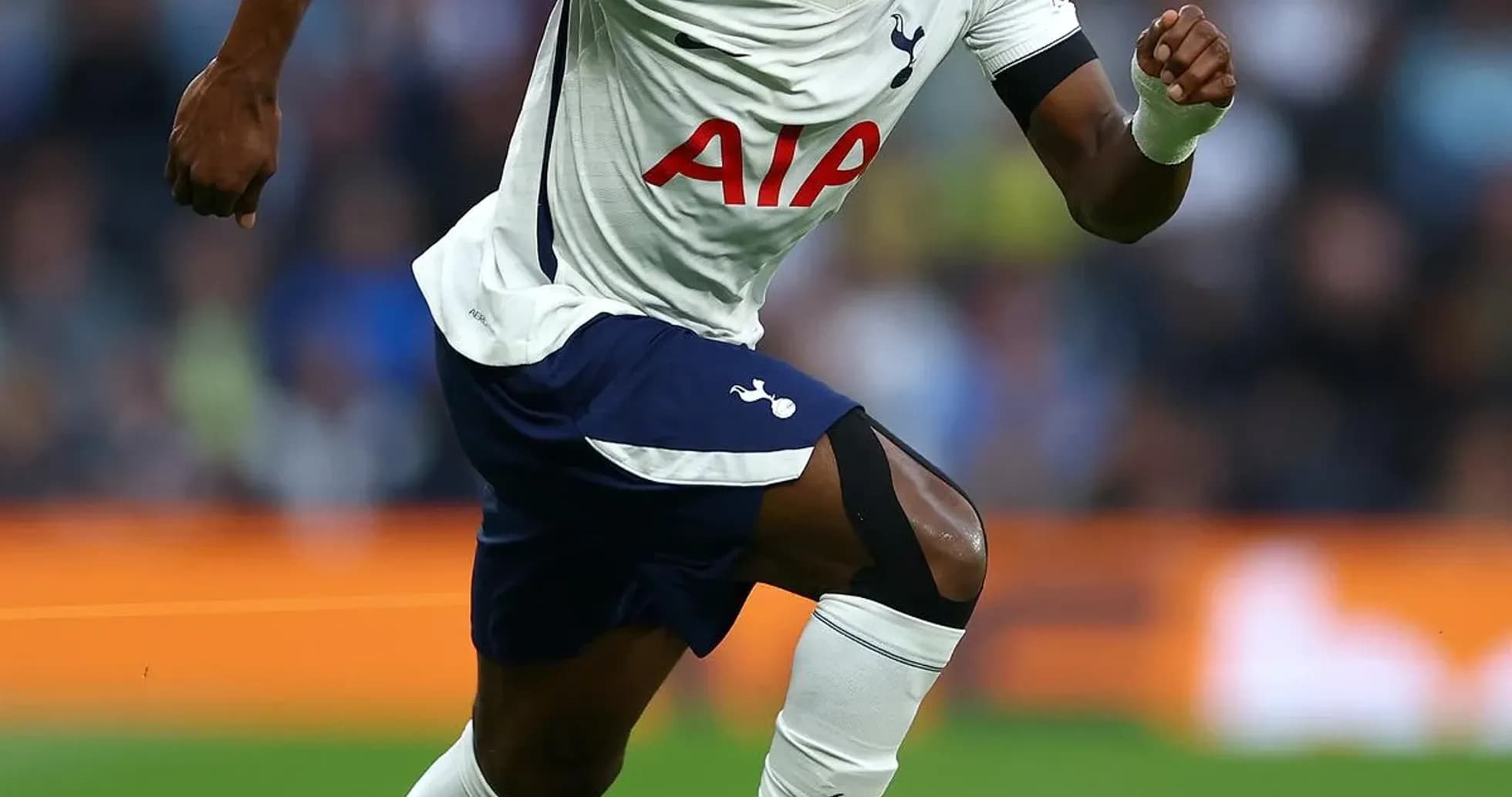 Player sprinting with ball during match for Tottenham Player sprinting with ball during match for Tottenham