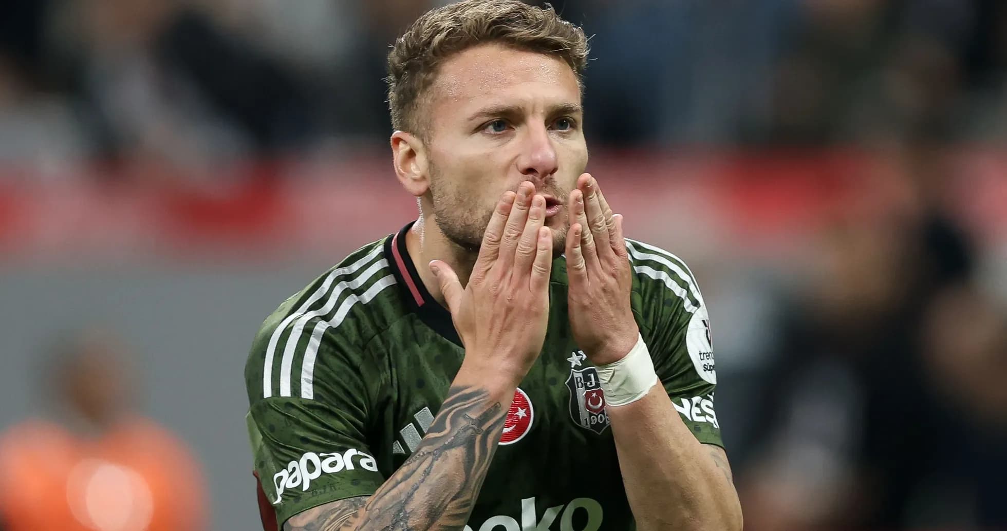 Player blowing kisses during a football match Player blowing kisses during a football match