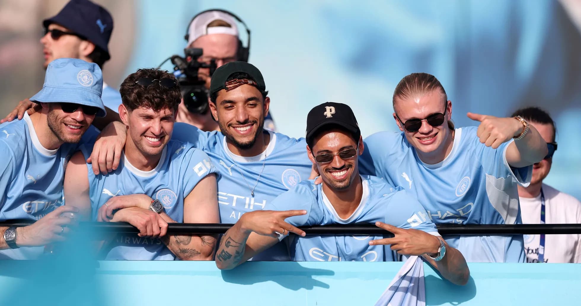 Five fans celebrating in Manchester City jerseys Five fans celebrating in Manchester City jerseys