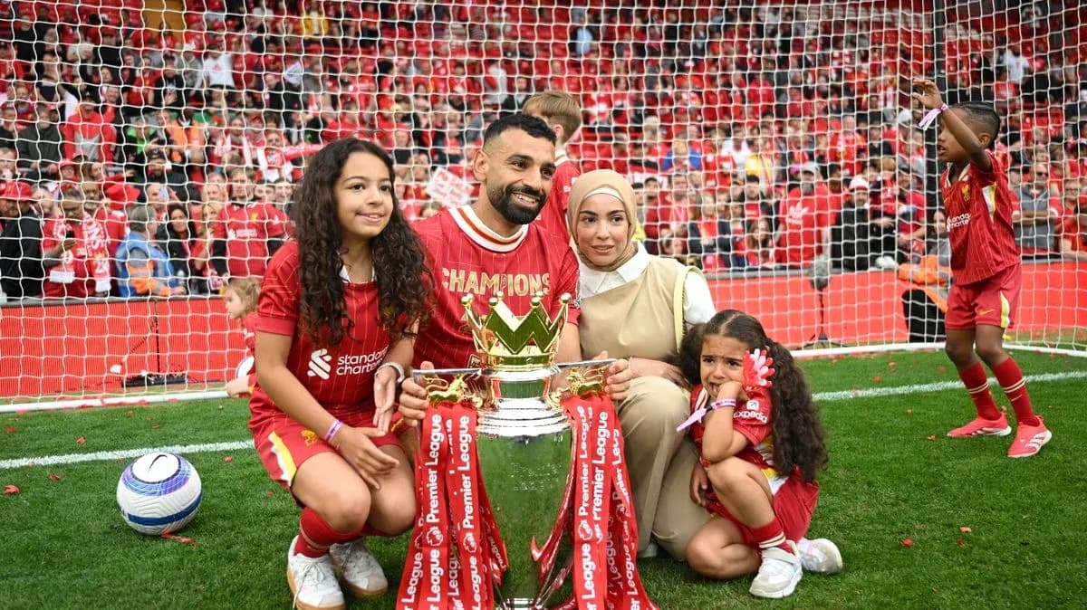 Player celebrating Premier League win with family and trophy Player celebrating Premier League win with family and trophy