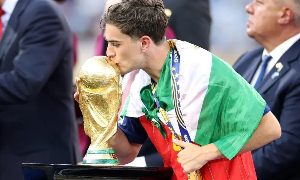 Player kissing FIFA World Cup trophy on podium Player kissing FIFA World Cup trophy on podium