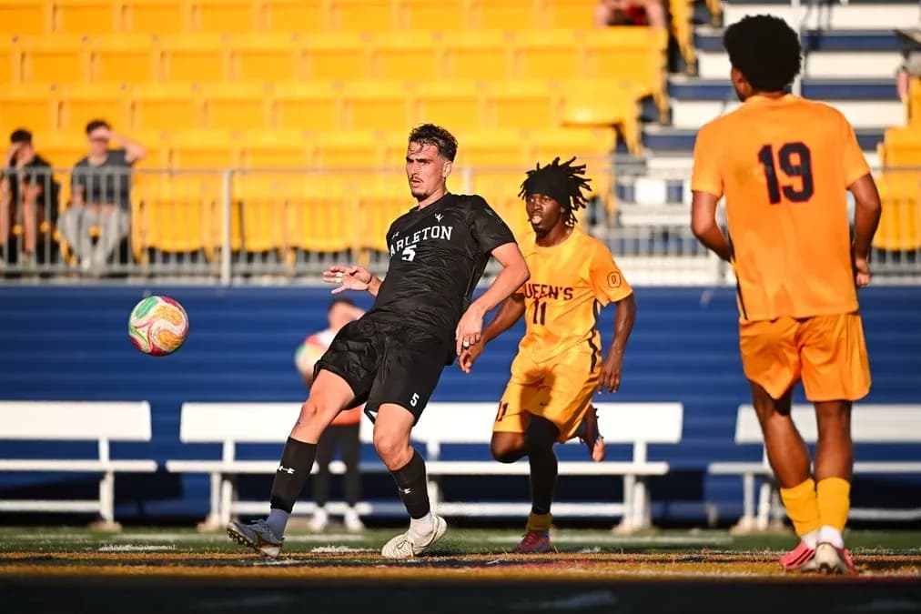 Player in black kicking ball during soccer match Player in black kicking ball during soccer match