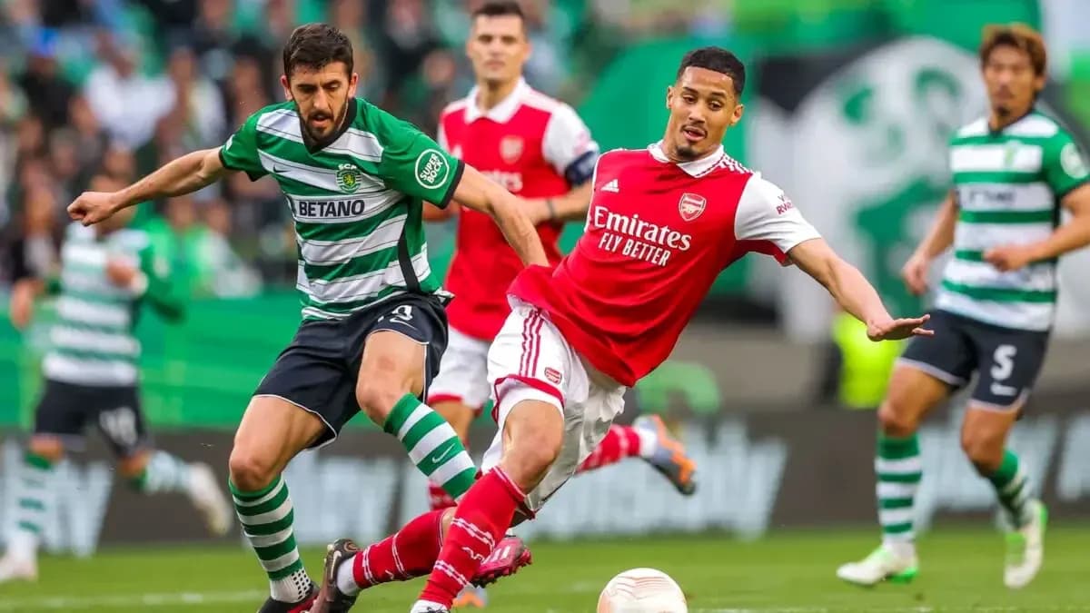 Sporting CP player challenges Arsenal player for the ball Sporting CP player challenges Arsenal player for the ball