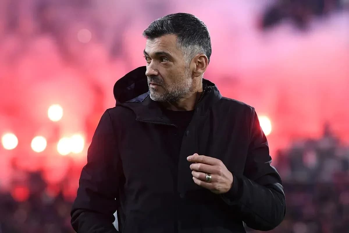 Coach observing match with stadium smoke in background Coach observing match with stadium smoke in background
