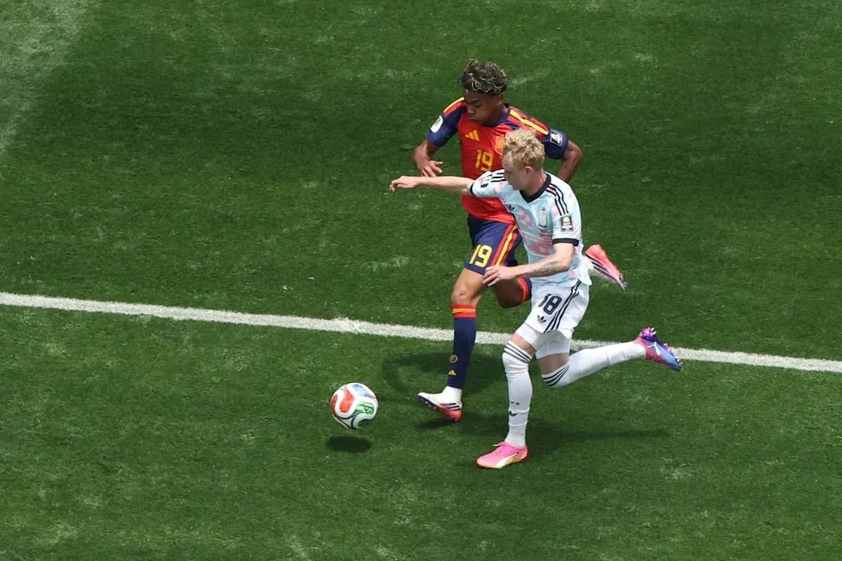 Two players contesting the ball on the field Two players contesting the ball on the field