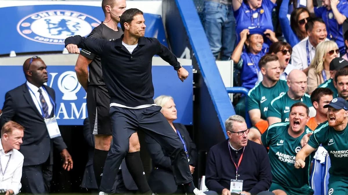 Coach celebrating during match with spectators in background Coach celebrating during match with spectators in background