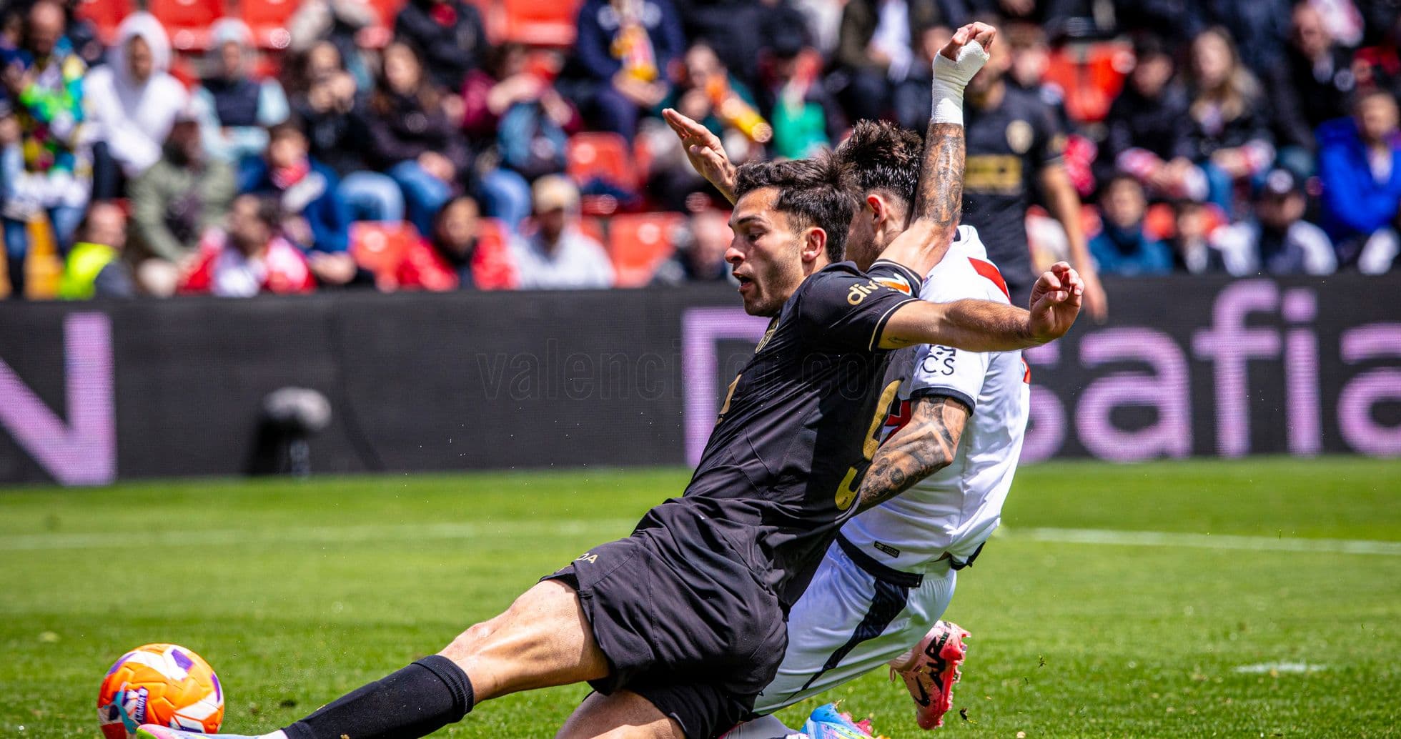 Player tackling opponent during Valencia match Player tackling opponent during Valencia match
