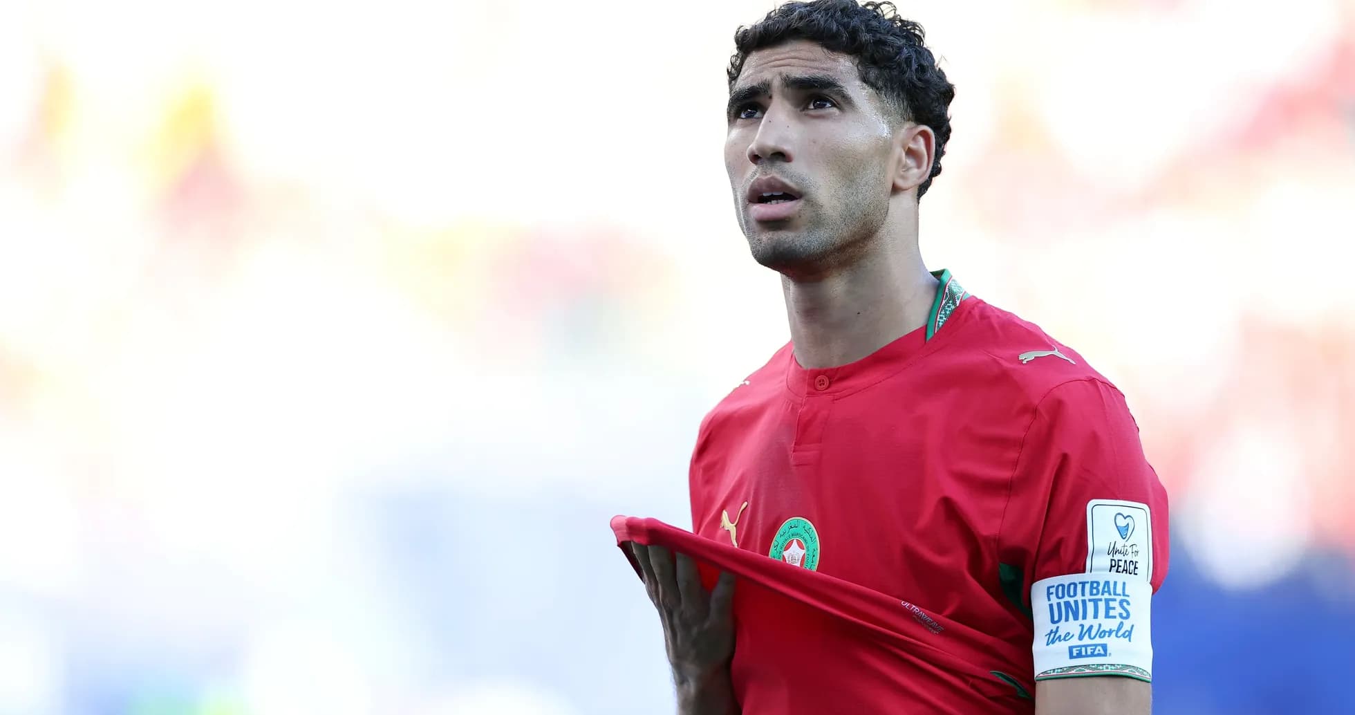 Player in red jersey looking up during match Player in red jersey looking up during match