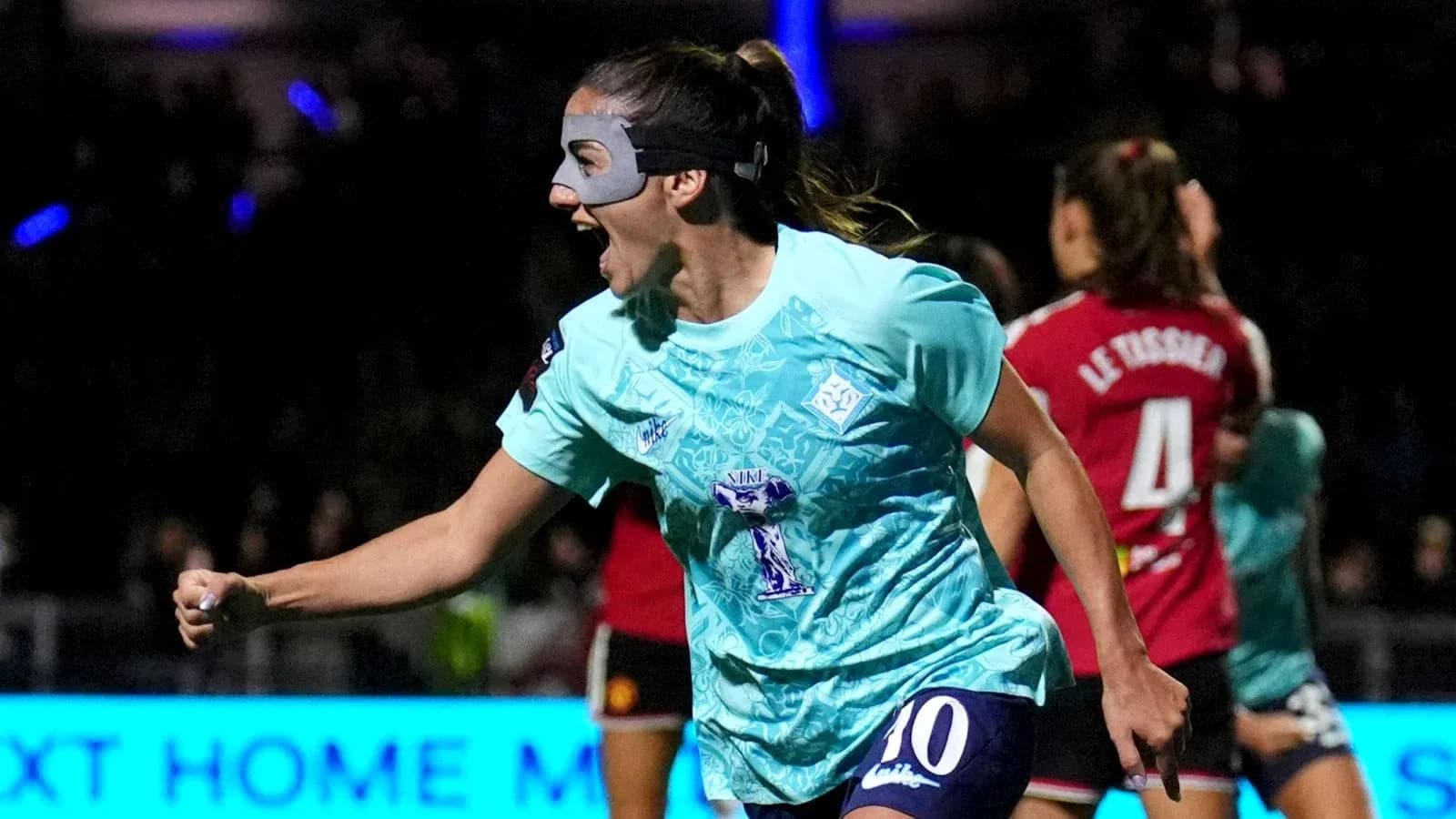 Player celebrating a goal wearing a protective mask Player celebrating a goal wearing a protective mask
