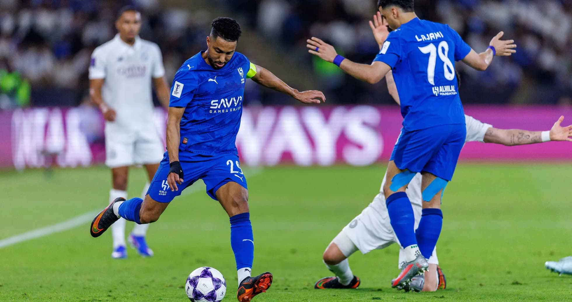Player dribbling the ball during a football match Player dribbling the ball during a football match