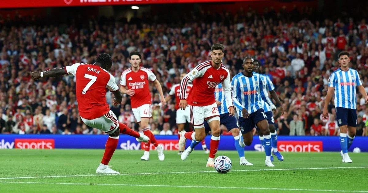 Saka kicking the ball during Arsenal match Saka kicking the ball during Arsenal match
