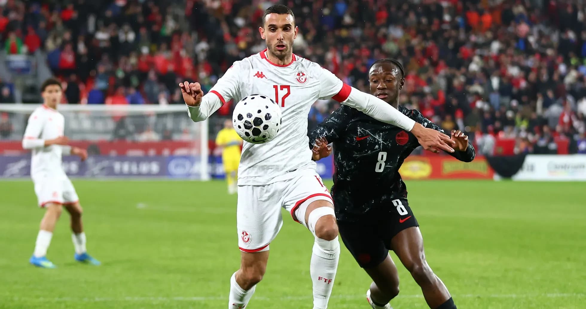 Two players contesting the ball during a match Two players contesting the ball during a match