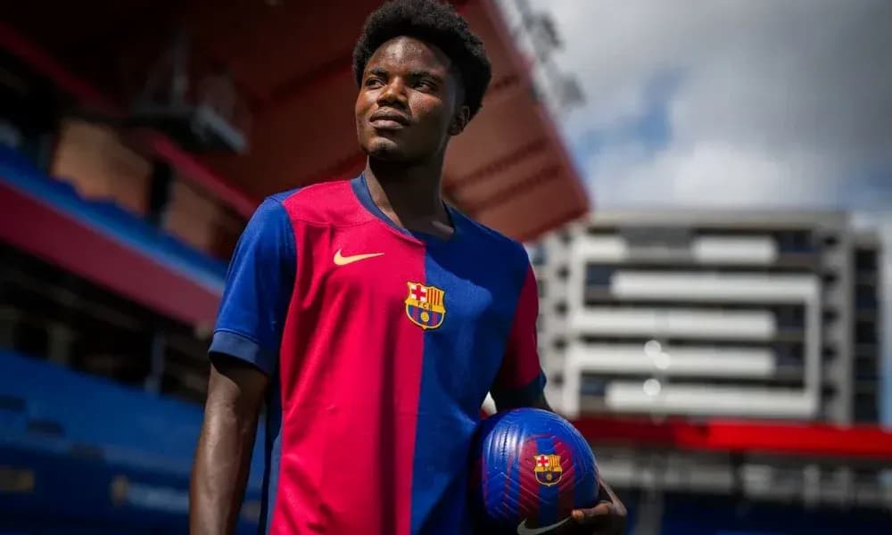 Player in Barcelona jersey holding a football Player in Barcelona jersey holding a football