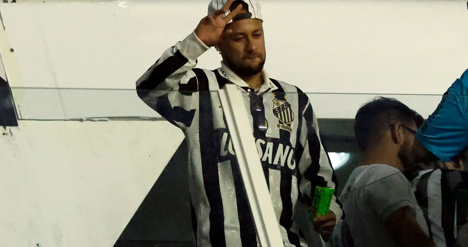 Man waving while wearing Santos FC jersey Man waving while wearing Santos FC jersey