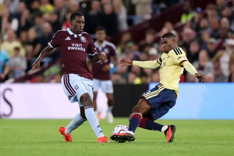 Two players competing for the ball on the field Two players competing for the ball on the field