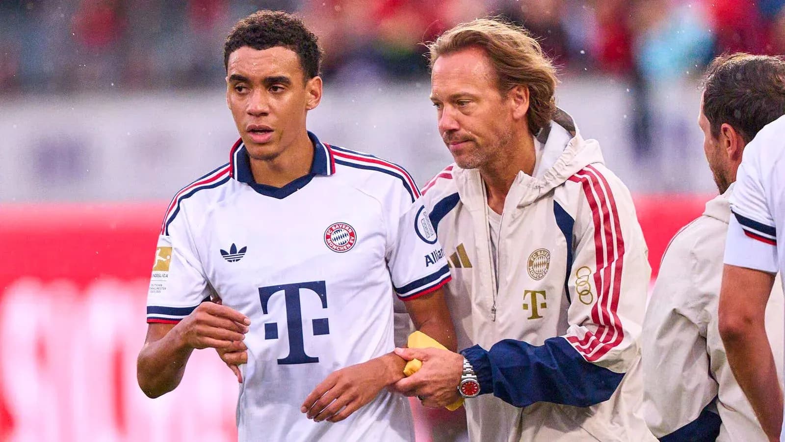 Bayern Munich player receiving assistance from staff Bayern Munich player receiving assistance from staff