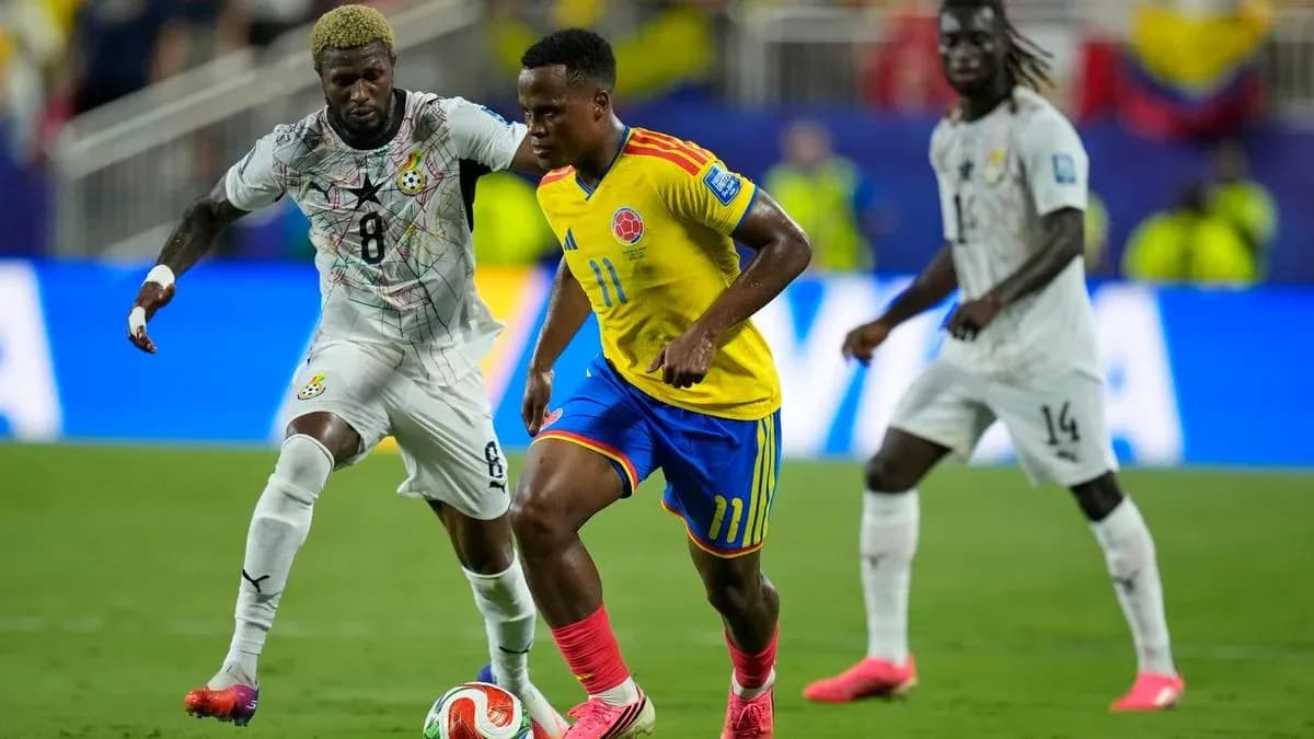 Colombian player dribbling past Ghanaian defender Colombian player dribbling past Ghanaian defender