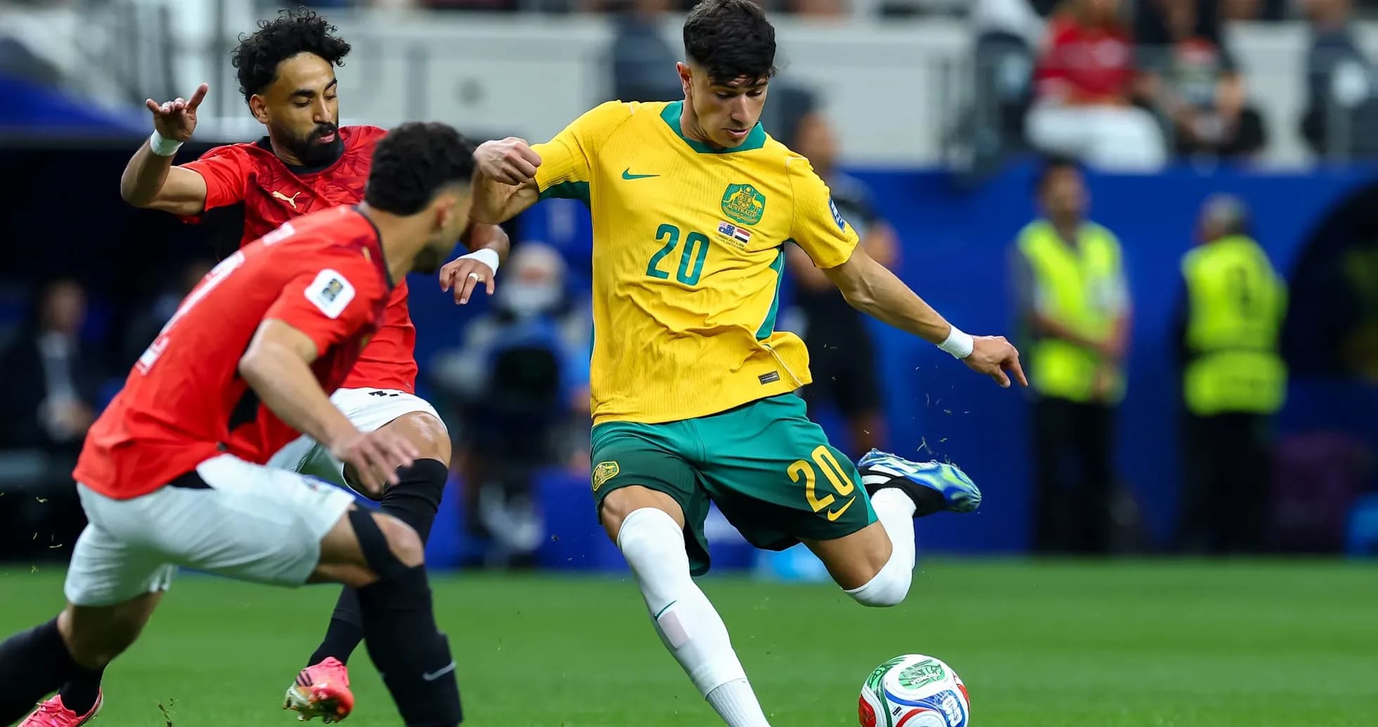 Australian player dribbling against Egyptian defenders Australian player dribbling against Egyptian defenders