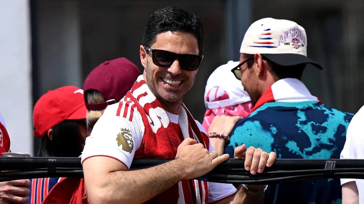 Man smiling with sunglasses and scarf at event Man smiling with sunglasses and scarf at event