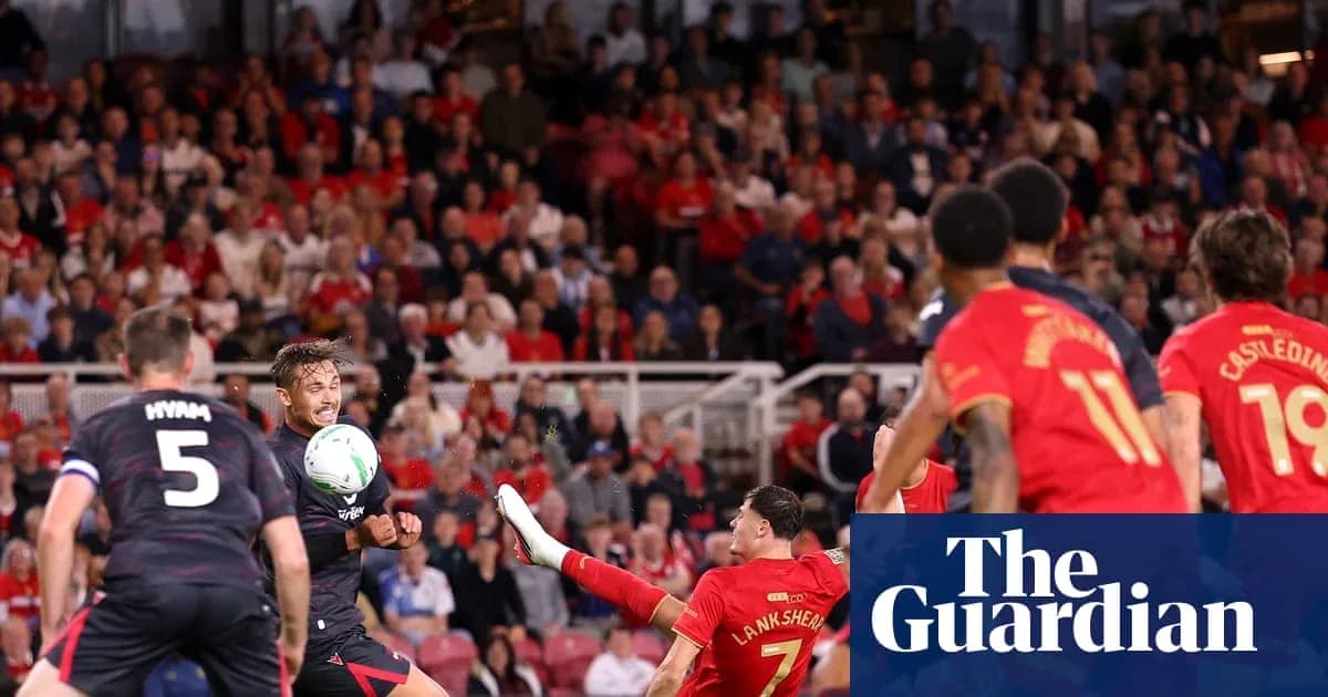 Players contesting the ball during a football match Players contesting the ball during a football match