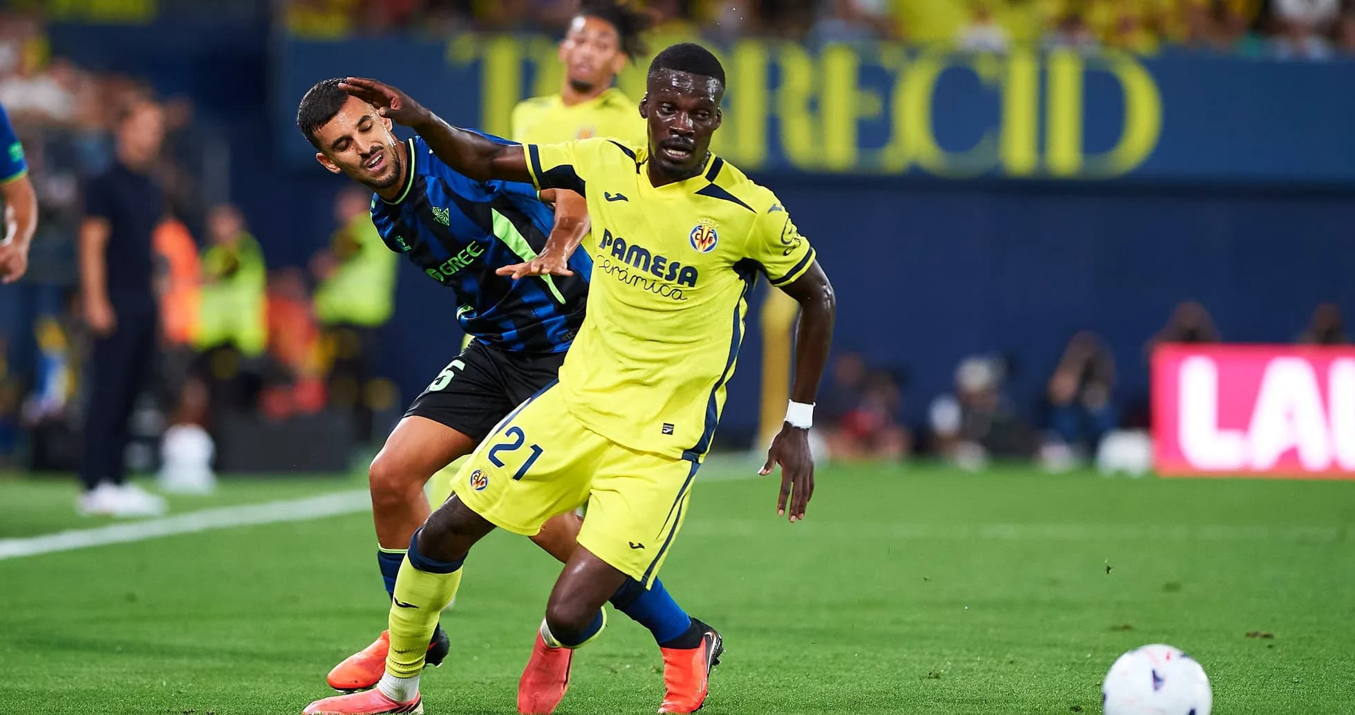 Player in yellow dribbling past opponent in blue Player in yellow dribbling past opponent in blue