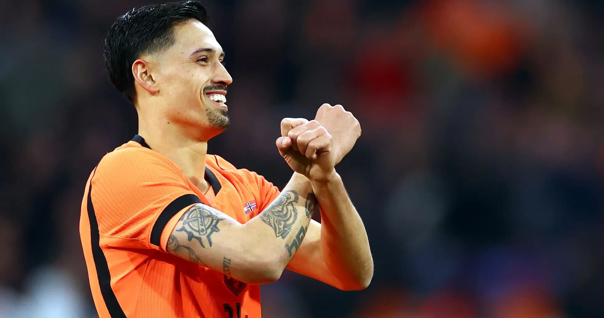 Player celebrating in orange jersey during match Player celebrating in orange jersey during match
