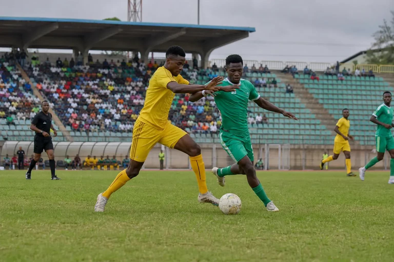 Players contesting for the ball in CAF match Players contesting for the ball in CAF match