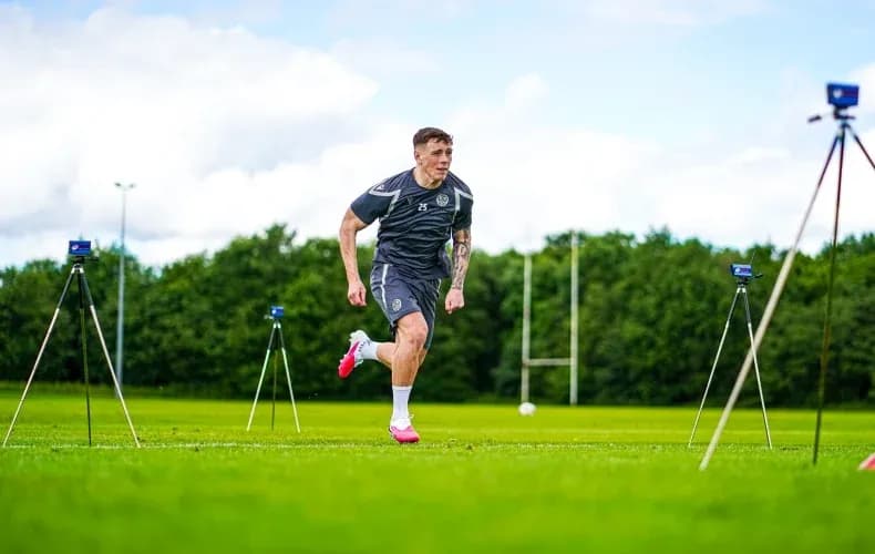 Player sprinting during training session on field Player sprinting during training session on field