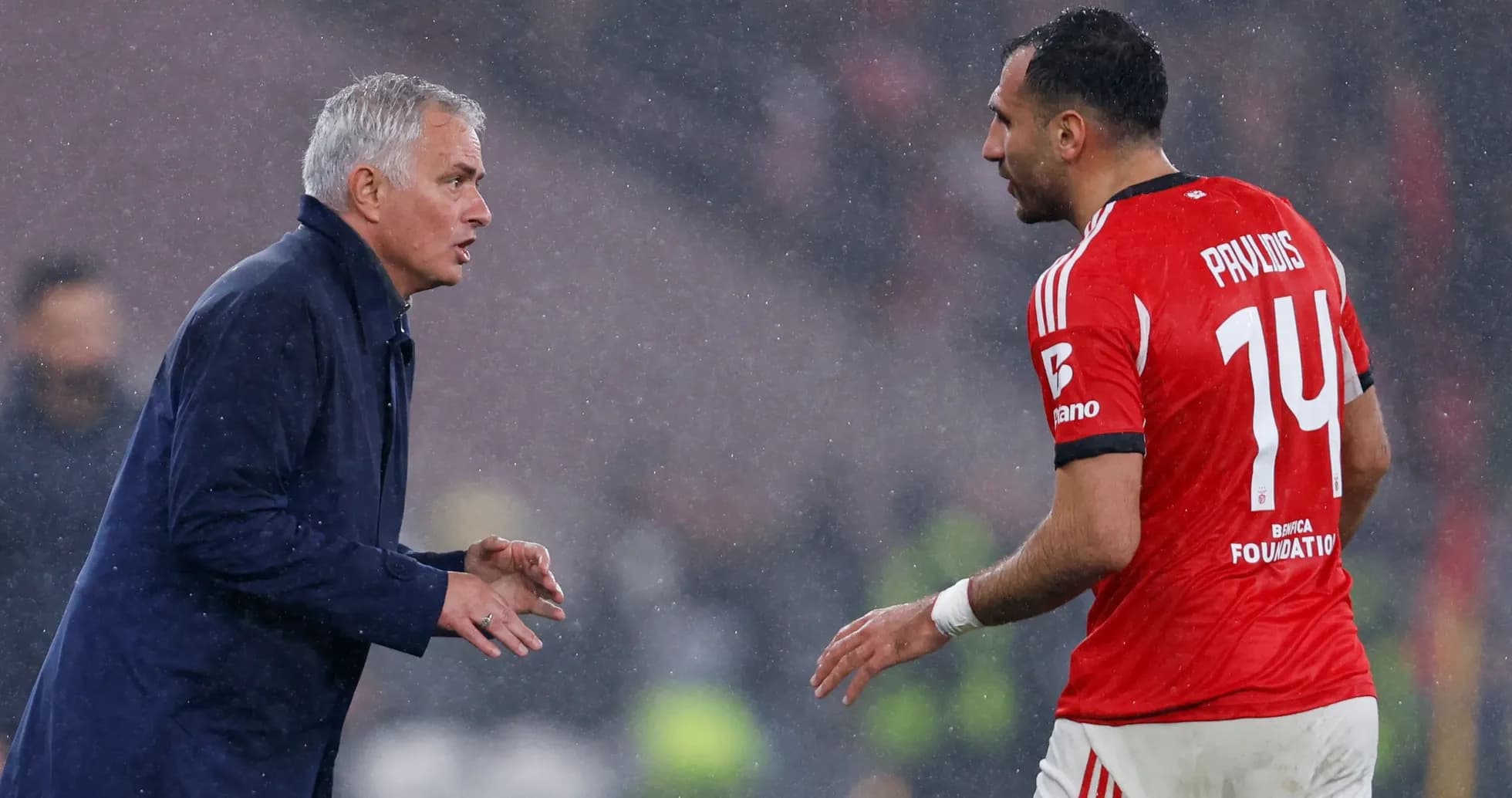 Coach speaking to player during rainy match Coach speaking to player during rainy match