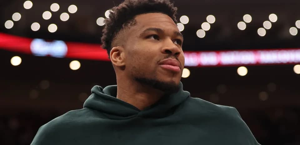 Player wearing hoodie on court during game Player wearing hoodie on court during game