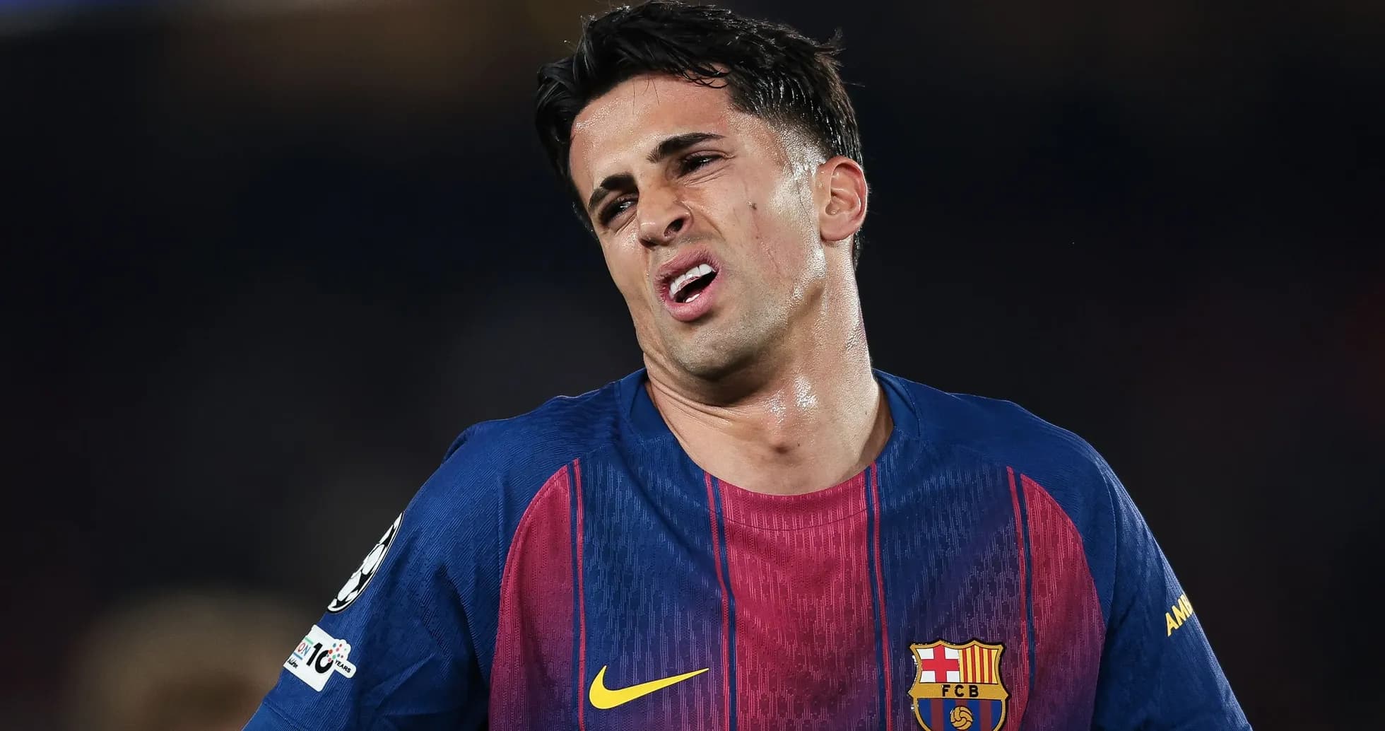 Player in FC Barcelona jersey showing frustration on field Player in FC Barcelona jersey showing frustration on field