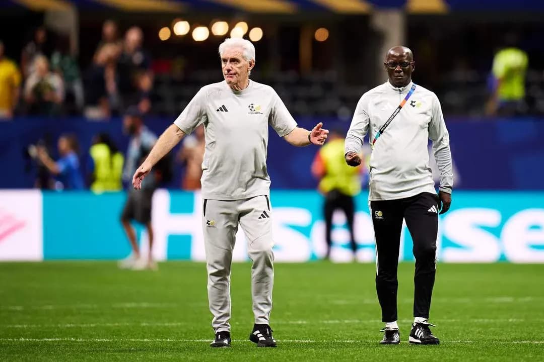 Two coaches walking on the pitch during warm-up Two coaches walking on the pitch during warm-up