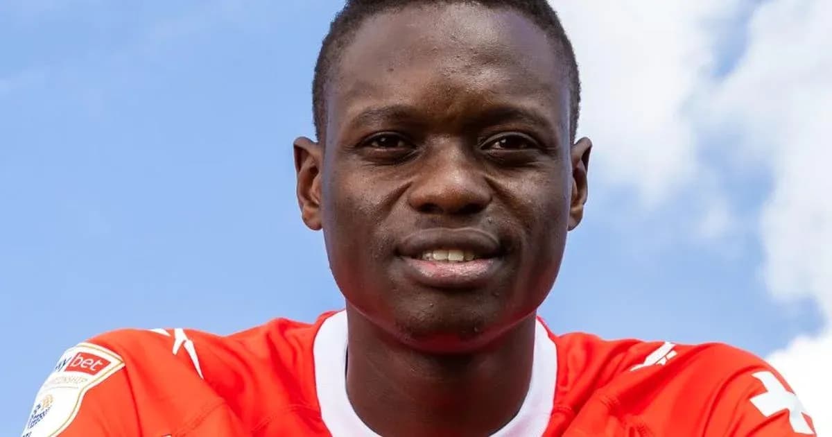 Player posing in red jersey against blue sky Player posing in red jersey against blue sky