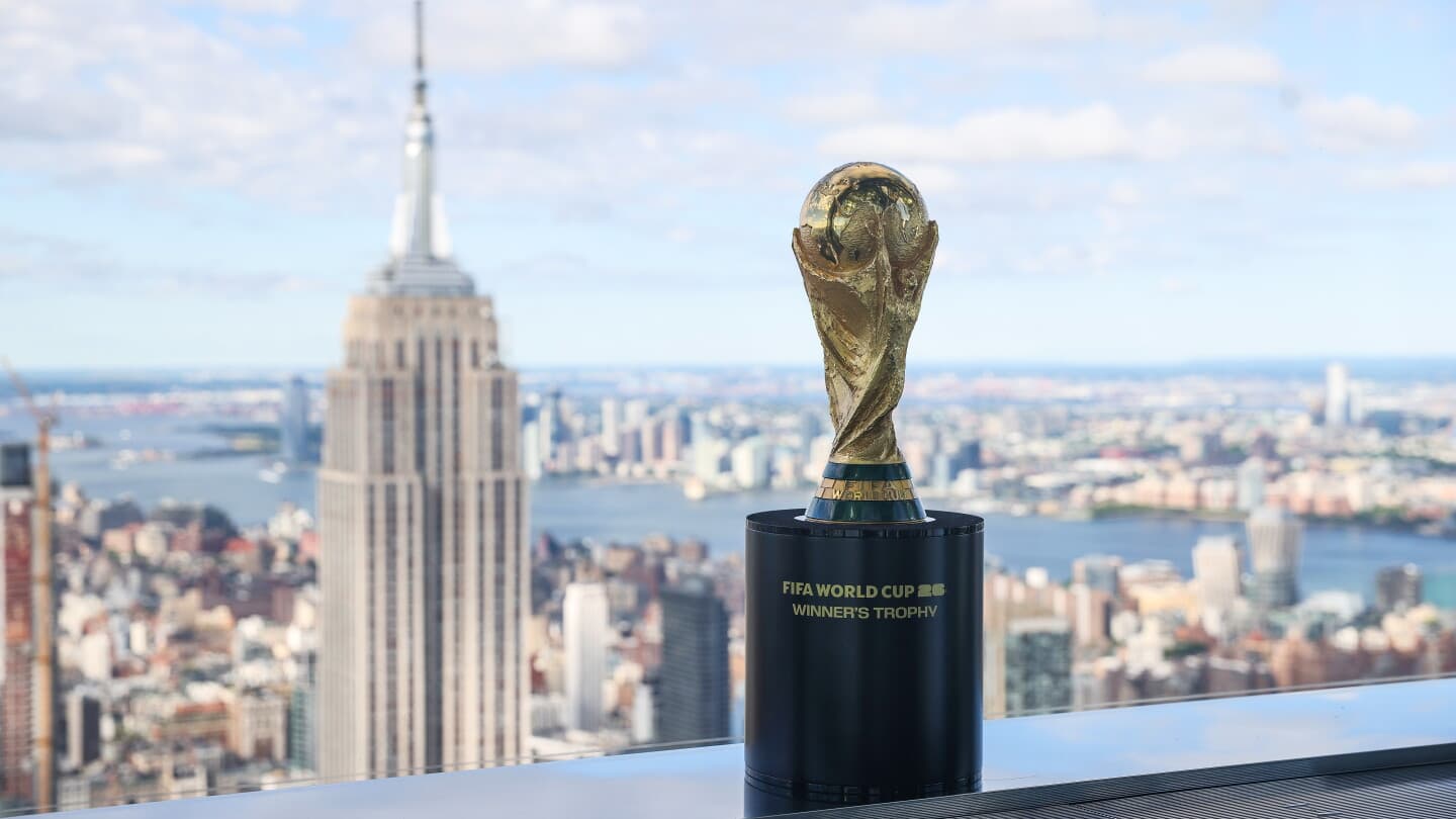 FIFA World Cup trophy displayed with city skyline FIFA World Cup trophy displayed with city skyline
