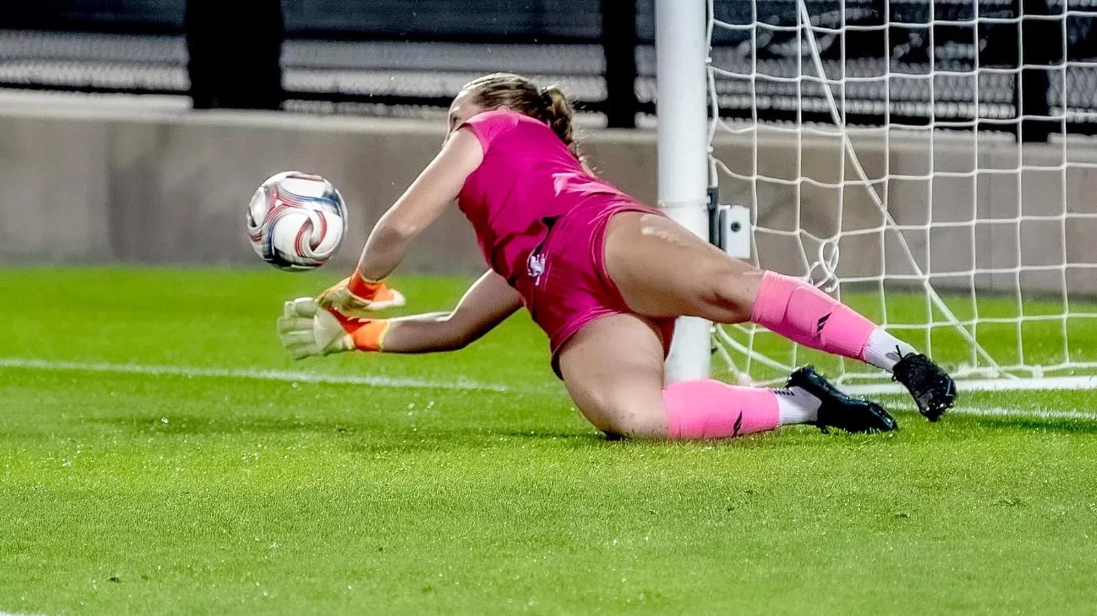 Goalkeeper diving to save the ball in match Goalkeeper diving to save the ball in match