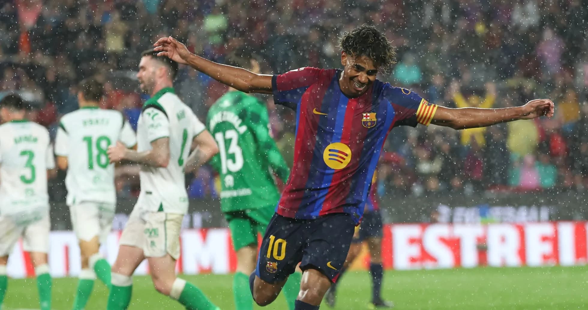 Barcelona player celebrating in the rain during match Barcelona player celebrating in the rain during match