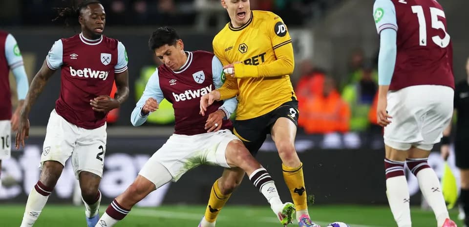 West Ham player tackling Wolves forward during match West Ham player tackling Wolves forward during match