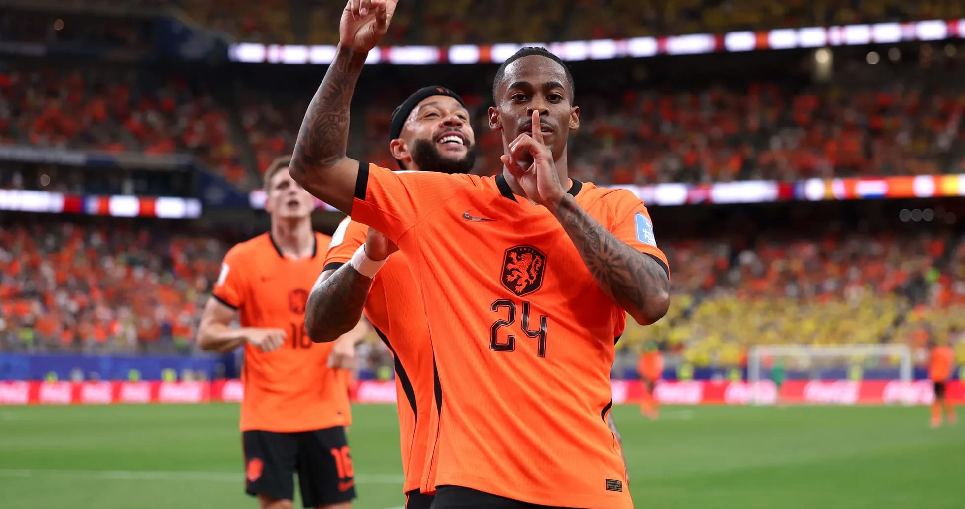 Players celebrating a goal in orange Netherlands jerseys Players celebrating a goal in orange Netherlands jerseys