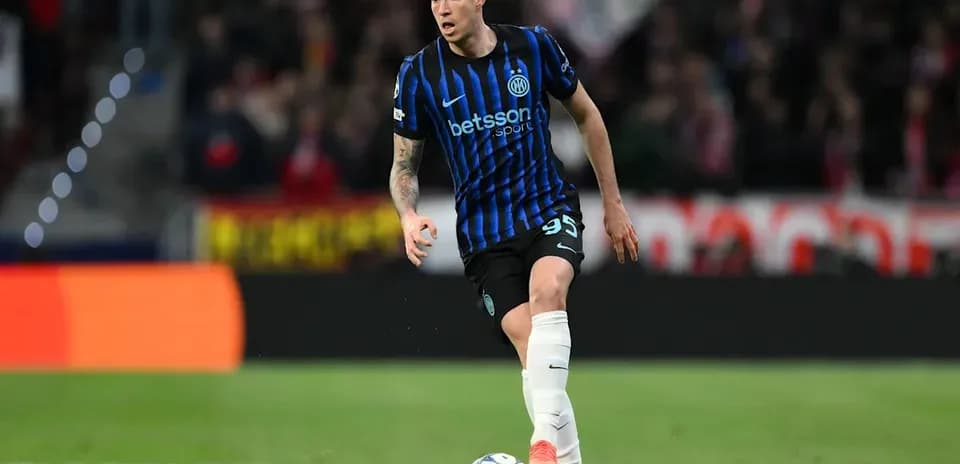 Player in blue and black kit dribbling football Player in blue and black kit dribbling football