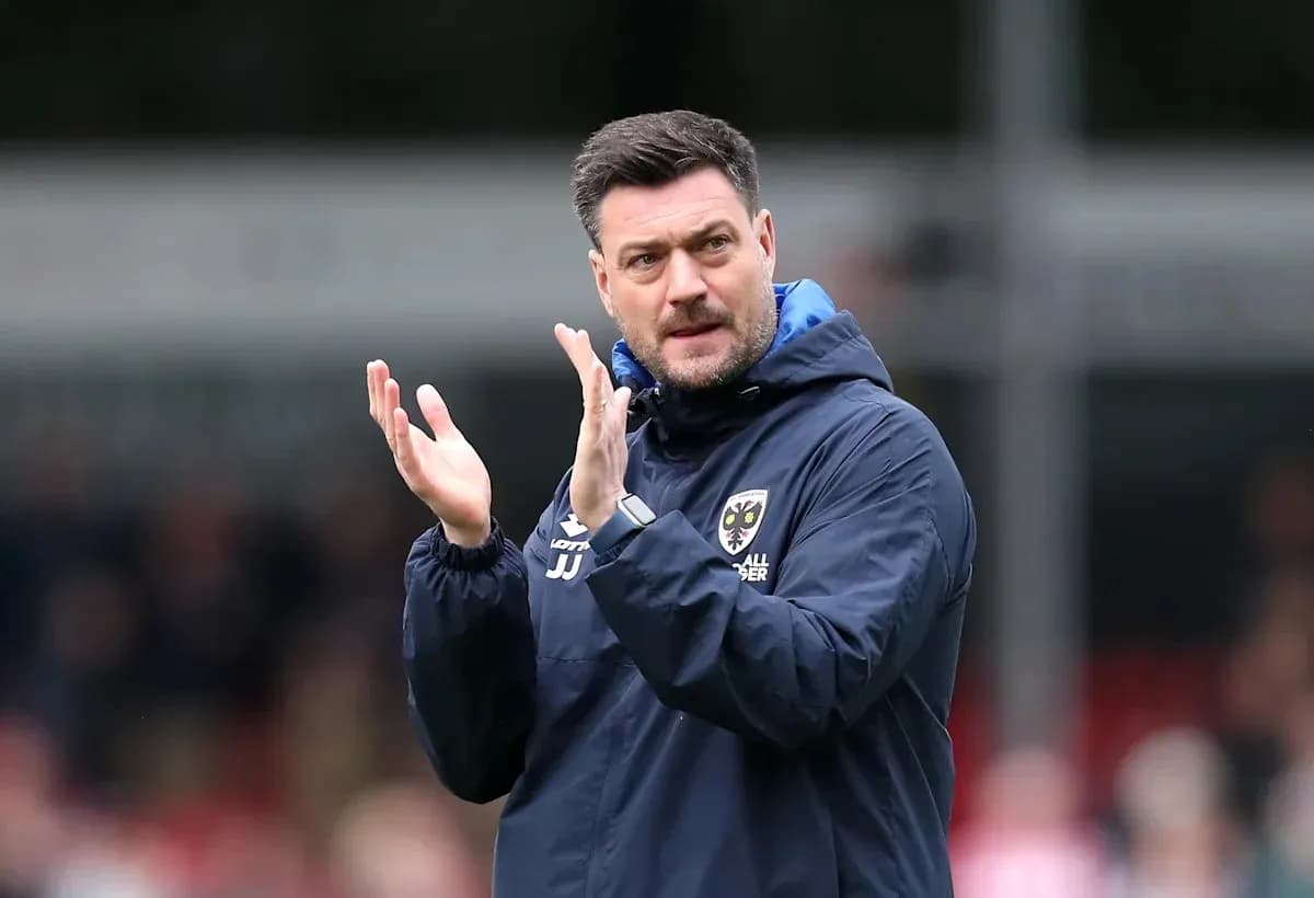 Manager applauding during a match on the sidelines Manager applauding during a match on the sidelines