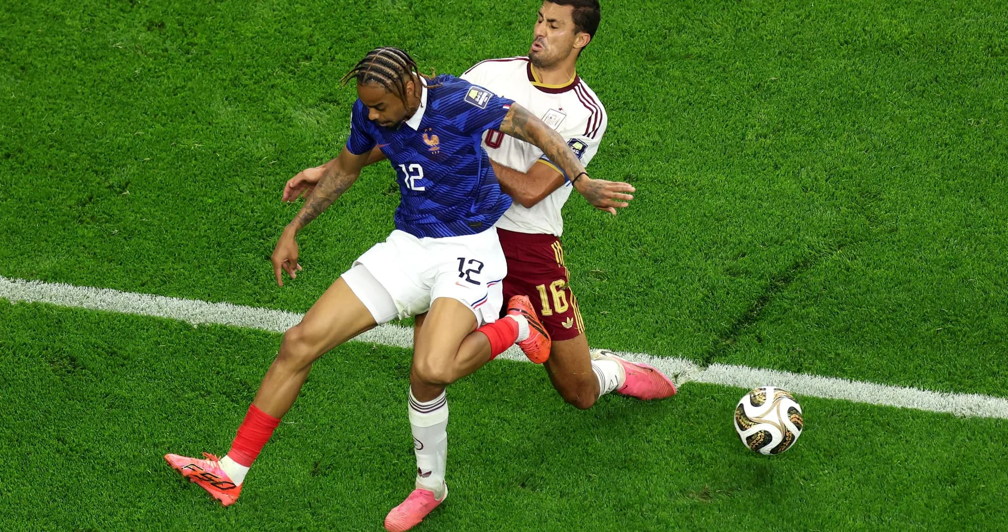 Two players competing for the ball on field Two players competing for the ball on field